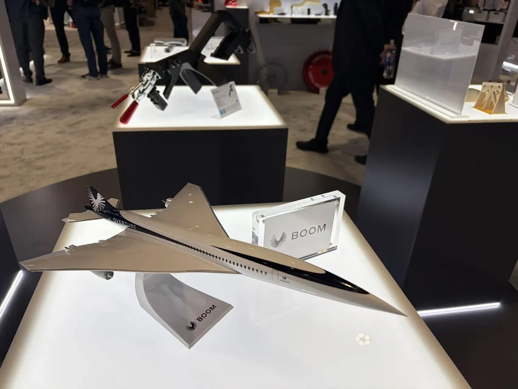 Scale model of the Boom Supersonic Overture airliner on a lit plinth at the Stratasys booth
